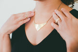 Brass Shield Necklace on model