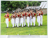 Postcard of soldiers in redcoats, marching and holding muskets
