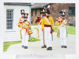 Postcard of soldiers in yellow uniforms, marching and playing instruments