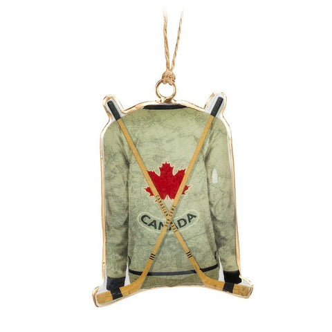Decorative ornament shaped like a hockey jersey with a maple leaf and 'Canada' text on a white background.