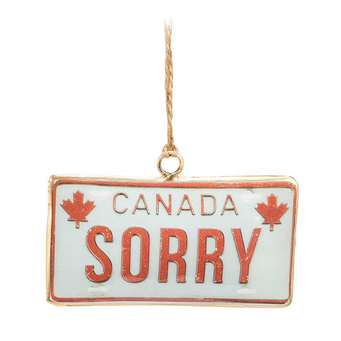 Decorative ornament resembling a Canadian license plate with 'SORRY' text and maple leafs.