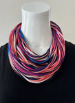 Wild fire ( a multi- colour of pink, purple, blue, white, and black ) necknot on display