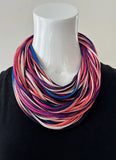 Wild fire ( a multi- colour of pink, purple, blue, white, and black ) necknot on display