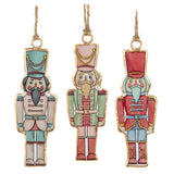 Three colorful nutcracker ornaments hanging against a white background