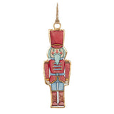 Decorative nutcracker ornament with red outfit and blue pants on a white background