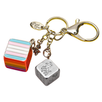 Cube with stripes and silver cube with a zebra on it attached to a clasp.