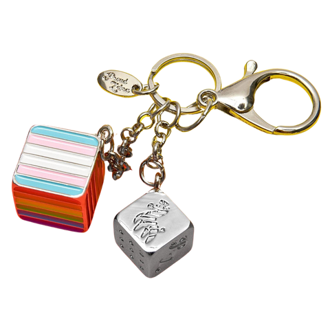 Cube with stripes and silver cube with a zebra on it attached to a clasp.