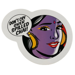 Round sticker with a stylized face and 'Don't cry over spilled chai!' text on a white background