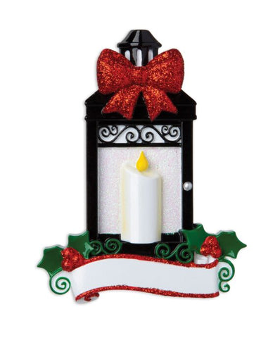 Decorative Christmas lantern with a candle, red bow, and green holly leaves on a white background.