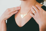 Brass Shield Necklace on model 