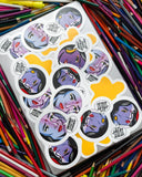 Stickers on a laptop on a pile of colorful pencils