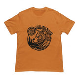 An orange short-sleeve crewneck t-shirt featuring a black graphic print of a bear's head inside a circular frame with the text 'EVERY CHILD MATTERS' and a mountain and pine tree design.