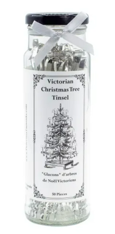 Jar of Victorian Christmas tree tinsel with a decorative label on a white background