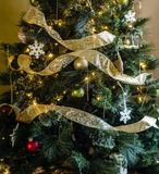 Decorated Christmas tree with gold ribbons and ornaments