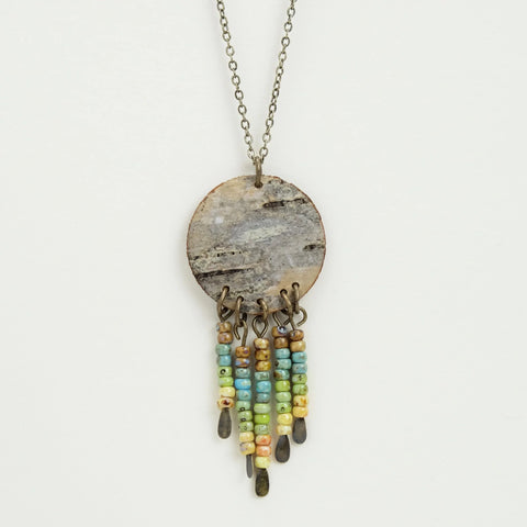 Close up of birch bark pendant necklace with Picasso beads