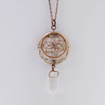 Close up of birch bark pendant necklace with dream catcher and quartz crystal