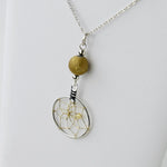Close up of the dream catcher necklace with gold druzy beads