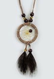Close product shot of dream catcher necklace in brown