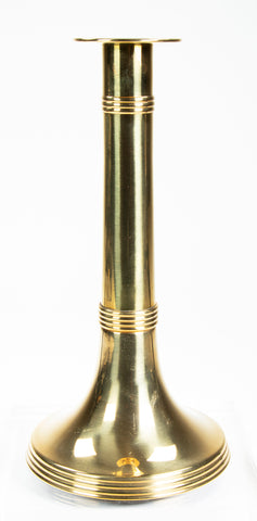 Brass candlestick with gun barrel stem and concave base