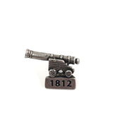 Pewter pin of mini cannon, 1812 engraved at bottom 