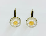 Vintage button hanging earrings with gold flower on white background