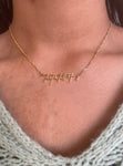 Gold necklace shown worn