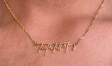 Gold necklace shown worn close up