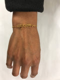 Gold bracelet shown worn on wrist