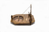 Sideview of brass pendulum sundial and compass 