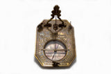 Overhead view of brass pendulum sundial and compass