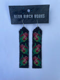 Close product shot of beaded earrings, each with 3 red and pink rosebuds on a black background.