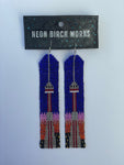 Pair of beaded earrings showing the CN Tower at sunset,