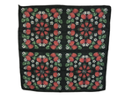 Black background with strawberries, white flowers and green leaves.