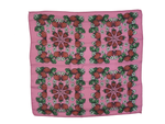 Pink background with strawberries, white flowers and green leaves.