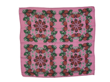 Pink background with strawberries, white flowers and green leaves.