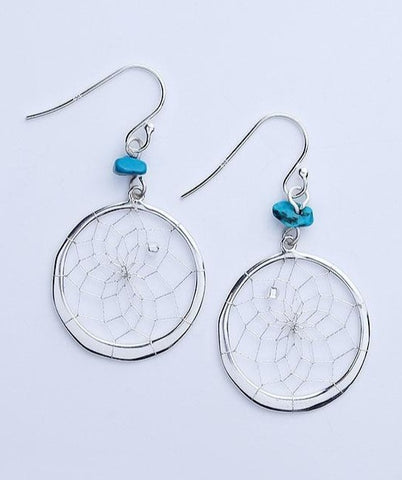 Close product shot of sterling silver dream catcher earrings with turquoise stone.