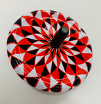 Tin spinning top with kaleidoscope design in black red and white