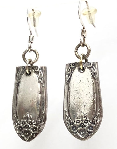 Two silver flatware pieces with flower clusters attached to  earring hooks 