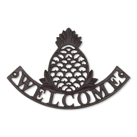 Cast iron sign with a pineapple over the word "welcome"