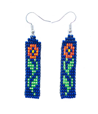 Close product shot of beaded earrings shown with red flower on navy blue background