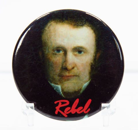 Portrait of William Lyon Mackenzie on a round button with the word Rebel in red at the bottom