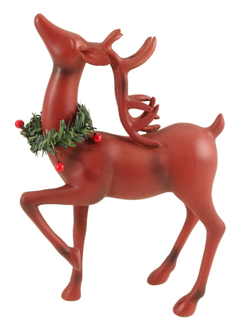 Standing red deer with a wreath around it's neck.