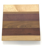 A square Board made of six stripes of different wood. 