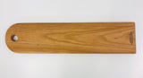A Baguette Board made with Cherry Wood. Hand Crafted in Canada is printed on the bottom edge (2).)