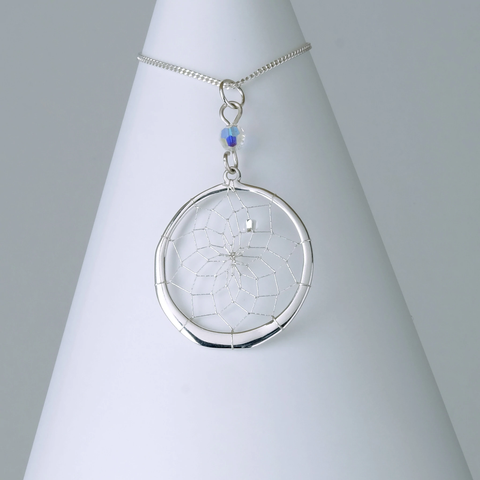 Close product shot of sterling silver dream catcher pendant with  Swarovski Crystal