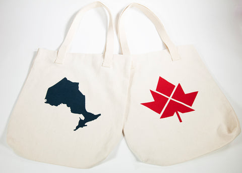 Two off-white tote bags; one with Blue Ontario print; one with Red Maple Leaf print 