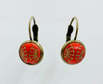 Vintage button hanging earrings with gold fan design on red backgrounds