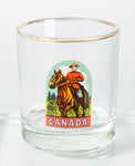 Gold rimmed bar glass with a vintage picture of a Mountie on a horse with Canada underneath