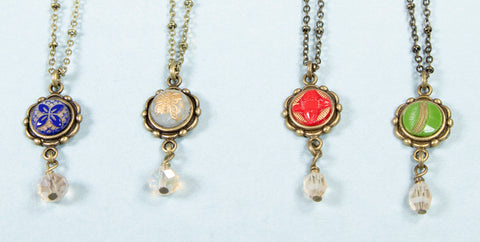 Four drop necklaces in blue, white, red and green