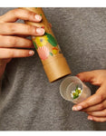 Person holding the Huckleberry kaleidoscope with flowers in the lens cap